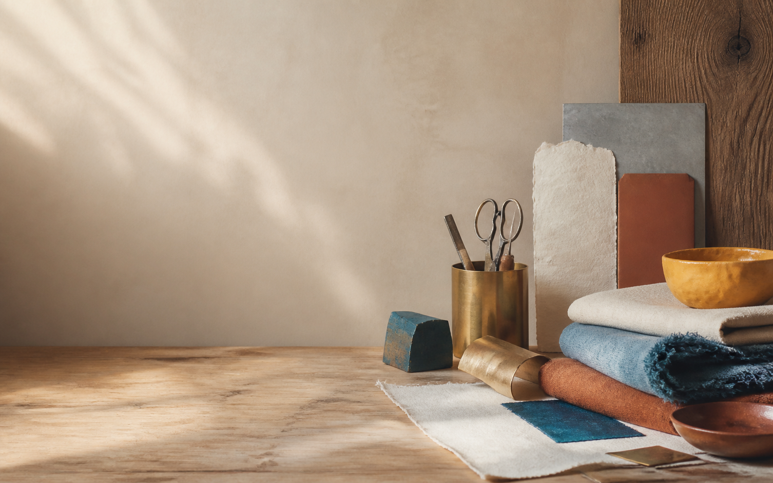 Warm studio materials with fabric, wood, and metal